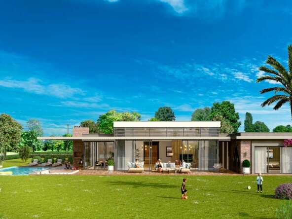 A house with a lawn and a pool Description automatically generated